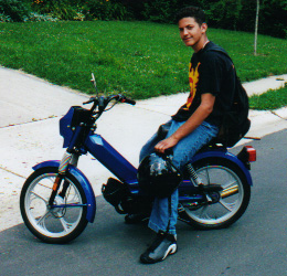 Avi with his moped before it was stolen and trashed